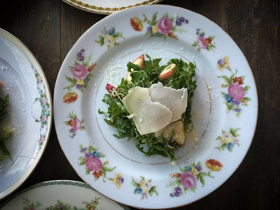 Arugula salad with shaved cheese and apple on a vintage porcelain plate at a Napa Valley private dinner